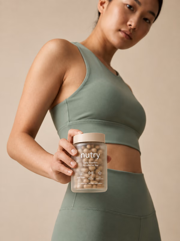 Woman in green activewear holding a jar of Nutry